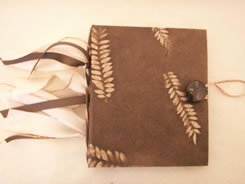 Warm brown finish with fern leaves embedded in this hand-made book