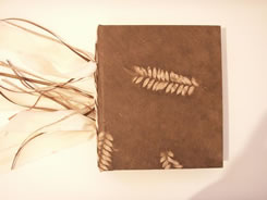 Hand-made book covered in brown suede and ferns
