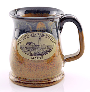 Warm tan speckled glaze, with dark navy blue, and a beautiful plaque on coffee mug